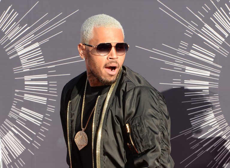 (FILES) This file photo taken on August 24, 2014 shows US musician Chris Brown arriving on the red carpet at the MTV Video Music Awards (VMA) at the Forum in Inglewood, California. US hip-hop star Chris Brown took to swearing and break-dancing as he ranted on July 23, 2015 about being stranded in the Philippines over a row with an influential sect. The 26-year-old was stopped from leaving the Philippine capital on July 22, a day after performing at a Manila concert, amid a fraud complaint filed against him by the indigenous Christian group Iglesia ni Cristo (Church of Christ).      AFP PHOTO / FILES / Mark Ralston