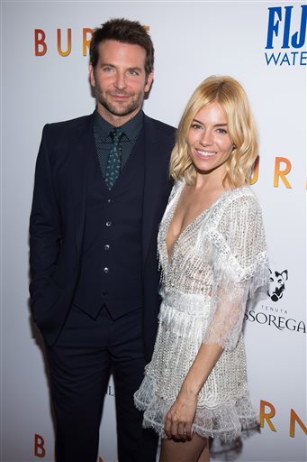 FILE - In this Tuesday, Oct. 20, 2015 file photo, Bradley Cooper, left, and Sienna Miller, attends the premiere of "Burnt" at the Museum of Modern Art, in New York. The movie opens nationwide on Oct. 30. (Photo by Charles Sykes/Invision/AP, File)