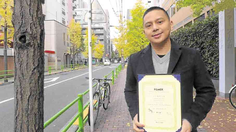 Eduardo Roy Jr. shows off Tokyo FILMeX certificate