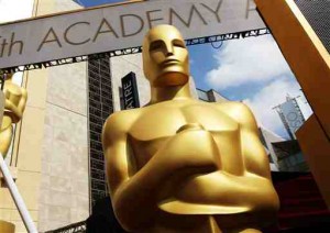 In this Feb. 21, 2015 file photo, an Oscar statue appears outside the Dolby Theatre for the 87th Academy Awards in Los Angeles. The largest black audience for the Academy Awards over the last dozen years came in 2005, when Chris Rock was host and Jamie Foxx and Morgan Freeman won the top male acting awards. Rock will be back as host this year, but it's an open question how many African American viewers will be tuning in. A lack of diversity in Oscar nominations have led to stars like Spike Lee and Jada Pinkett Smith calling for a boycott of the Academy Awards, scheduled for Feb. 28. (Photo by Matt Sayles/Invision/AP, File)
