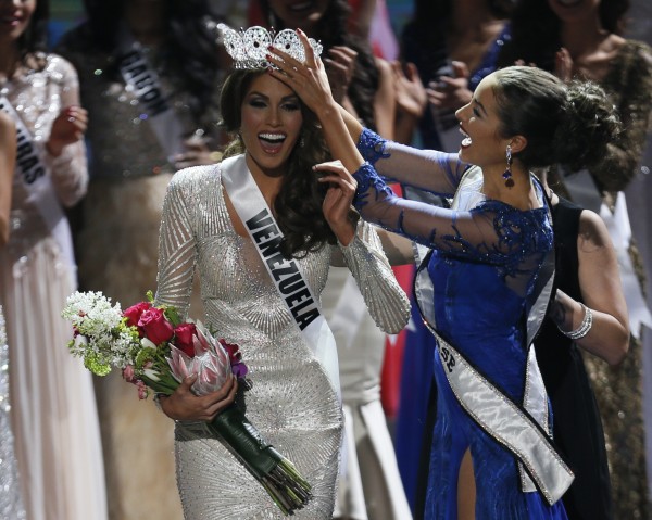 Miss Universe 2012 Olivia Culpo of the United States, right, crowns Miss Venezuela Gabriel Isler during the 2013 Miss Universe pageant in Moscow, Russia, Saturday, Nov. 9, 2013.  (AP Photo/Pavel Golovkin)