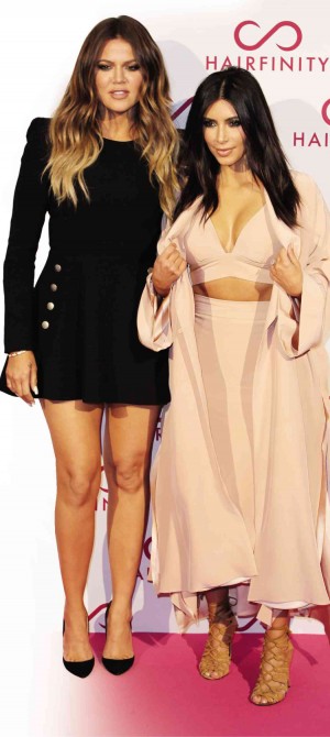 KHLOE (left) and Kim Kardashian are laughing all the way to the bank. AP