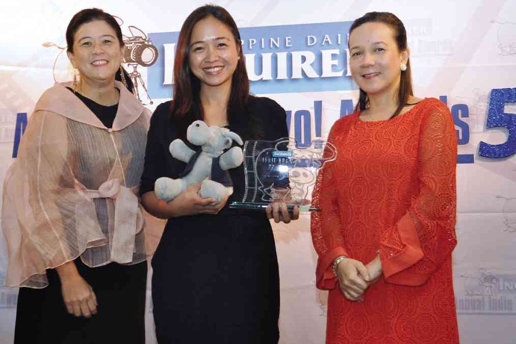 DOCUMENTARIAN Adjani Arumpac (center) receives trophy andGuyito from INQUIRER CEO and president Alexandra Prieto- Romualdez (left) and Sen. Grace Poe. INQSnap this page for additional content! RICHARD REYES