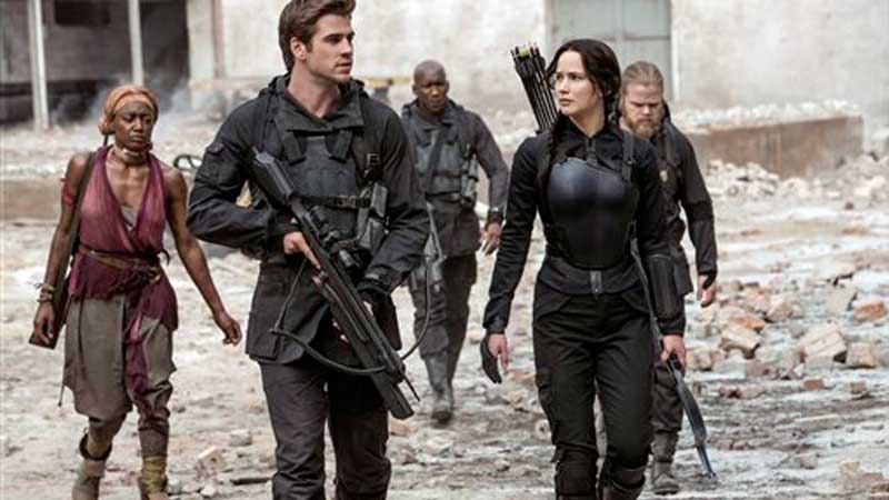 In this image released by Lionsgate, Jennifer Lawrence portrays Katniss Everdeen, right, and Liam Hemsworth portrays Gale Hawthorne in a scene from "The Hunger Games: Mockingjay Part 1." AP