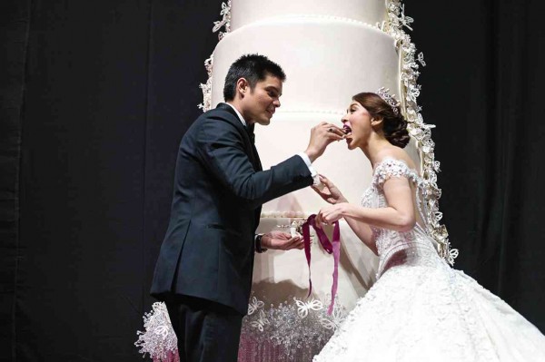 THE GROOM gives the bride a piece of wedding cake. jilson seckler tiu 