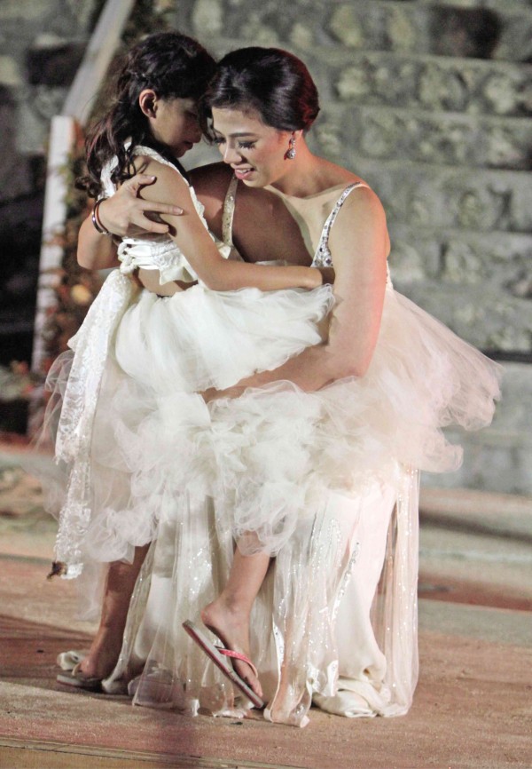 BRIDE Liza helps out "mini bride," daughter Amara. 