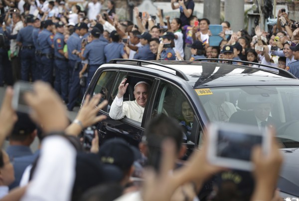 Pope Francis waves to Filipinos in Manila on Friday. AP