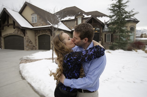 Jeff Bennion and his wife Tanya kiss in front of their home, Monday, Jan. 5, 2015, near Salt Lake City. Two Utah men set to appear in the reality TV show My Husbands Not Gay, say theyre fulfilled in their relationships to their wives even though theyre attracted to other men. The shows concept has come under fire since it was announced by the TLC network last month.  (AP Photo/Rick Bowmer)