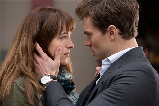 In this image released by Universal Pictures and Focus Features, Dakota Johnson, left, and Jamie Dornan appear in a scene from the film, "Fifty Shades of Grey."  AP