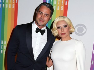 FILE - In this Dec. 7, 2014 file photo, Taylor Kinney and Lady Gaga attend the 37th Annual Kennedy Center Honors in Washington. Lady Gaga announced on her Instagram account Monday, Feb. 16, 2015 that she and Kinney are engaged. Her representative confirmed. Kinney stars in the NBC series “Chicago Fire” and also had a role in the film “Zero Dark Thirty.” Gaga’s hits include “Poker Face,” “Bad Romance” and “Applause.” She recently won her sixth Grammy Award this month for her album with Tony Bennett, “Cheek to Cheek.” (Photo by Greg Allen/Invision/AP, File)