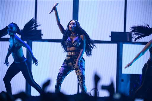 FILE - In this Sept. 19, 2014 file photo, Nicki Minaj performs at the iHeartRadio Music Festival in Las Vegas, Nev. Minaj says two members of her tour have been stabbed in Philadelphia, one of them fatally. Minaj wrote on Twitter Wednesday, Feb. 18, 2014, that the two had flown into Philadelphia for rehearsals two days ago. Philadelphia police say two men, ages 29 and 26, were stabbed early Wednesday outside a bar. They say the 29-year-old was killed and the younger man critically wounded. (Photo by Al Powers/Powers Imagery/Invision/AP, File)