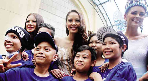 MISS World 2013 Megan Young (center)  and Miss World Philippines 2014 Valerie Weigmann (second from left) get a photo-op with young cancer patients during the inauguration of the new hematology-oncology ward at the  Philippine General Hospital in Manila. RICHARD A. REYES