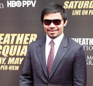 Manny Pacquiao thinks new house will impress his wife.  AFP 