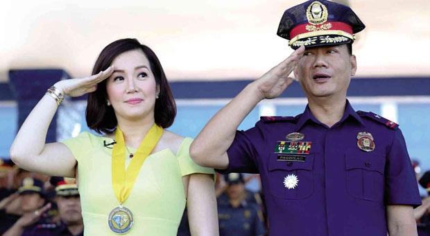 SNAPPY SALUTE  Kris Aquino and Quezon City police chief Supt. Joel Pagdilao give a snappy salute during the flag ceremony in Quezon City.  LYN RILLON