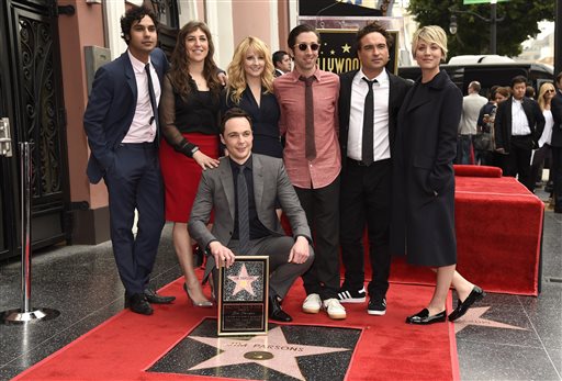 Kunal Nayyar, from left, Mayim Bialik, Melissa Rauch, Simon Helberg, Johnny Galecki and Kaley Cuoco, and center, Jim Parsons, who is honored with a star at the Hollywood Walk of Fame on Wed., March 11, 2015, in Los Angeles. (Photo by Chris Pizzello/Invision/AP)