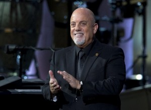 FILE - In this Nov. 19, 2014 file photo, Billy Joel, the recipient of the Library of Congress Gershwin Prize for Popular Song, stands on stage during a concert in his honor at DAR Constitution Hall in Washington. A representative for the 65-year-old singer said Joel and girlfriend Alexis Roderick are expecting their first child. They have been dating since 2009. The baby will be Joel’s second child and first with Roderick. He is the father of singer-songwriter Alexa Ray Joel. (AP Photo/Carolyn Kaster, File)
