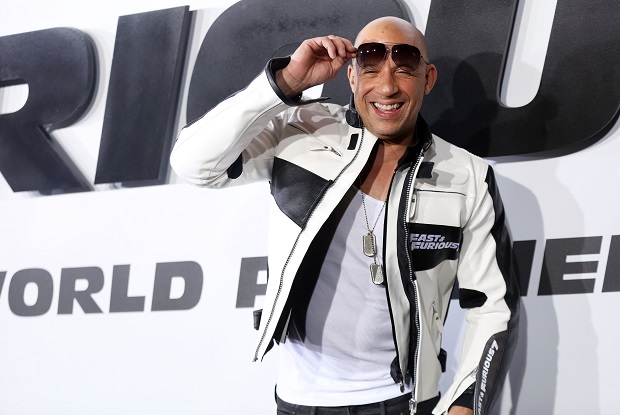 FILE- In this April 1, 2015, file photo, Vin Diesel arrives at the premiere of "Furious 7" at the TCL Chinese Theatre IMAX on Wednesday, April 1, 2015, in Los Angeles. The reigning box office champion might have slowed from its blockbuster debut, but "Furious 7" maintained first place for the third weekend in a row with an estimated $29.1 million, according to box office tracker Rentrak on Sunday, April 19, 2015. (Photo by Matt Sayles/Invision/AP, File)