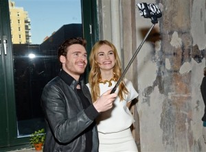 In this March 9, 2015 file photo, actors Richard Madden and Lily James take a selfie while attending AOL's BUILD Speaker Series to discuss their new film "Cinderella" at AOL Studios in New York City. Museums in the U.S. and Europe, including the Palace of Versailles outside Paris and Britain’s National Gallery in London, have banned selfies. AP