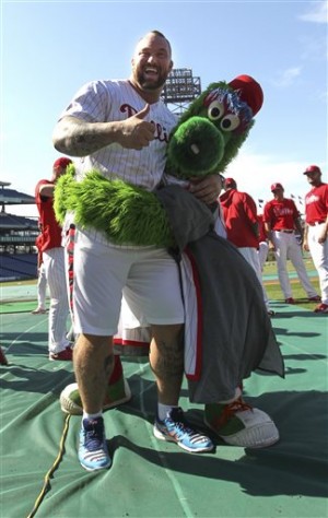 Actor Hafthor Julius Bjornsson, left, who plays Gregor Clegane also known as “The Mountain” on "Game of Thrones, clowns around with the Philadelphia Phillies Phanatic before a baseball game against the Arizona Diamondbacks, Friday, May 15, 2015, in Philadelphia. (AP Photo/Laurence Kesterson)