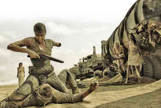 IMPERATOR Furiosa (Charlize Theron), a one-armed truck driver, goes toe to toe with the road warrior Max (Tom Hardy) while her fleeing allies watch. 