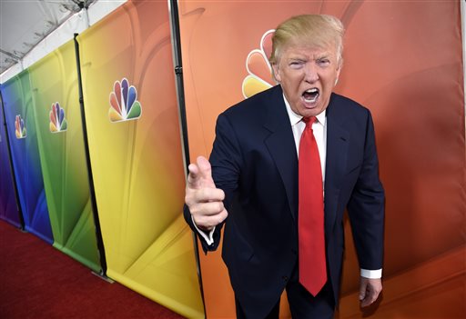 In this Jan. 16, 2015, file photo, Donald Trump, host of the television series "The Celebrity Apprentice," mugs for photographers at the NBC 2015 Winter TCA Press Tour in Pasadena, Calif. NBC on Monday, June 29, said that it is ending its business relationship with Trump, now a Republican presidential candidate, because of comments he made about immigrants during the announcement of his campaign. PHOTO BY CHRIS PIZZELLO/INVISION/AP