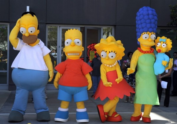 This May 7, 2009 file photo shows people costumed as characters from 'The Simpsons' (L-R: Homer, Bart, Lisa, Marge and Lisa) welcoming  guests at the Fox Studios in Los Angeles, California, before a dedication ceremony for the first day of issue of the Simpsons' stamps by the US Postal Service. Homer and Marge are to separate after more than 25 years together on hit comedy "The Simpsons," its executive producer revealed.  In a link on the show's Twitter feed June 10, 2015, Al Jean said it will emerge at the start of the show's 27th season in September that their relationship has been strained for some time.   "The Simpsons" -- which first aired in December 1989 -- averages 7.7 million viewers on television and online in the United States. Millions more enjoy the show in foreign markets, according to US parent network Fox. Last month, Fox announced that it had renewed the long-running series for two more seasons. AFP PHOTO