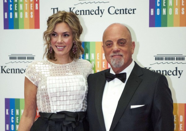 FILE - In this Dec. 7, 2013 file photo, Kennedy Center Honoree Billy Joel,right, and Alexis Roderick arrive at the Kennedy Center Honors gala dinner in Washington. Joel married girlfriend Alexis Roderick in a surprise ceremony at the couples annual July 4 party. The singers spokeswoman Claire Mercuri says New York Gov. Andre Cuomo presided over Saturday's nuptials at Joel's Long Island estate.AP