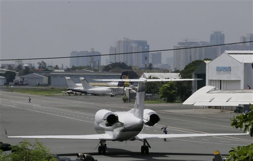 A Gulf Stream private jet chartered by Grammy award-winning singer Chris Brown, sits at the end of a taxiway housing private hangars of the Manila Domestic Airport at suburban Pasay city, south of Manila, Philippines Thursday, July 23, 2015. Chris Brown, who performed at a packed concert Tuesday night, was barred from leaving the country following fraud allegations against him and his promoter for a canceled concert last New Year's Eve in the Philippines. (AP Photo/Bullit Marquez)