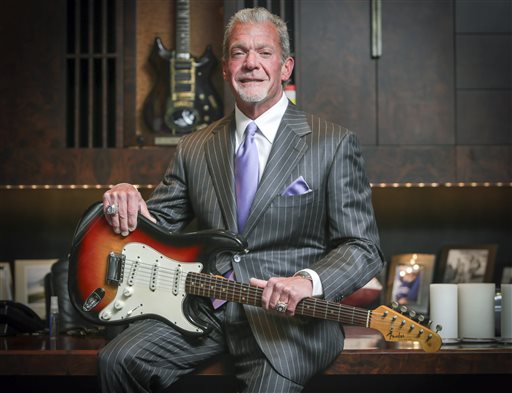 In this June 10, 2014 photo, Indianapolis Colts owner and CEO Jim Irsay holds in Indianapolis the Fender Stratocaster guitar that Bob Dylan played at the Newport Folk Festival in 1965. Irsay purchased it at auction for just under $1 million. Festival producer Jay Sweet said through a spokeswoman Friday, July 24, 2015, the opening day of this year's three-day outdoor festival in Newport, R.I., that the guitar had returned to the festival to celebrate the 50th anniversary of the performance when Dylan first went electric on stage. AP