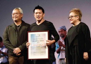 BRILLANTE Ma. Mendoza, director of opening film “Taklub,” receives a certificate of appreciation from Millado (left) and Guillen. Richard Reyes 