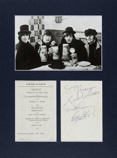 This undated photo provided by Heritage Auctions from an upcoming Beatles collection sale shows  Swiss restaurant menu card signed by the Beatles. AP