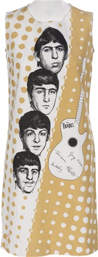 This undated photo provided by Heritage Auctions from an upcoming Beatles collection sale shows a 1960's era dress illustrated with portraits of the Fab Four, which will be auctioned in New York on Sept. 19. The collection, spanning the band’s entire career, is from the estate of Uwe Blaschke a noted German Beatles historian who died in 2010. (Heritage Auctions via AP)