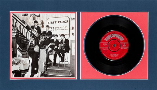 This undated photo provided by Heritage Auctions from an upcoming Beatles collection sale shows a signed copy of their first hit, “Love Me Do,” which will be auctioned in New York on Sept. 19. The collection, spanning the band’s entire career, is from the estate of Uwe Blaschke a noted German Beatles historian who died in 2010. (Heritage Auctions via AP)