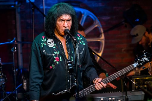 In this Aug. 16, 2015, file photo, Gene Simmons performs during the "Music On A Mission" benefit concert held at Lucky Strike Live - Hollywood in Los Angeles. Lt. John Jenal says a warrant was served Thursday, Aug. 20, 2015, at the Simmons home in Benedict Canyon near Beverly Hills, Calif., investigating Internet crimes against children. Jenal says the detectives involved want to emphasize that Simmons and his family were "extremely cooperative" and none of them are suspected of a crime. (Photo by Paul A. Hebert/Invision/AP, File)
