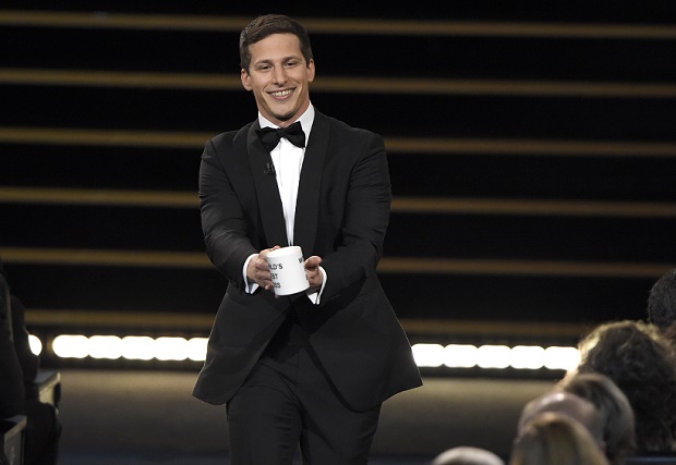 Host Andy Samberg prepares to present a coffee mug to Lorne Michaels at the 67th Primetime Emmy Awards on Sunday, Sept. 20, 2015, at the Microsoft Theater in Los Angeles. (Photo by Chris Pizzello/Invision/AP)