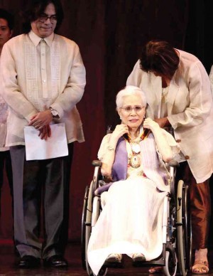 ARMIDA Siguion-Reyna receives medal  from CCP head Emily Abrera, while son Carlos looks on. 