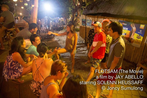 Director Jay Abello talks with the cast before shooting a scene. 