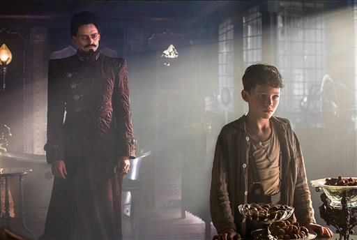 This image released by Warner Bros. Pictures shows Levi Miller, right, and Hugh Jackman in a scene from the film, "Pan." (Laurie Sparham/Warner Bros. Pictures via AP)