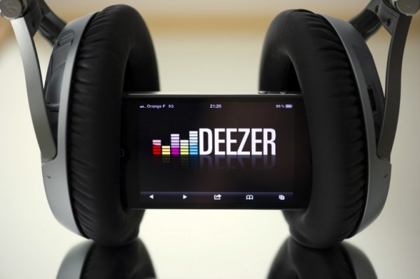 A file picture taken on October 9, 2012 in Paris shows headphones set up on a smartphone connected to French music streaming website Deezer. French music-streaming service Deezer announced on October 27, 2015 the indefinite postponement of its plans to launch an initial public offering on the Paris stock exchange. AFP PHOTO / LIONEL BONAVENTURE