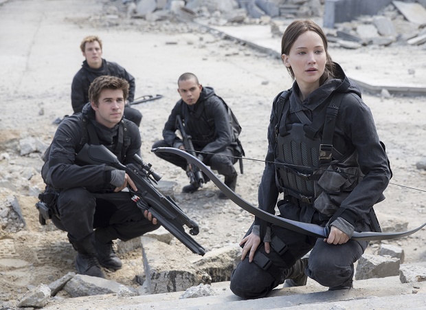 This photo provided by Lionsgate shows, Liam Hemsworth, left, as Gale Hawthorne, Sam Clafin, back left, as Finnick Odair, Evan Ross, back right, as Messalia, and Jennifer Lawrence, right, as Katniss Everdeen, in the film, "The Hunger Games: Mockingjay - Part 2."  The movie opens in U.S. theaters on Nov. 20, 2015. (Murray Close/Lionsgate via AP)