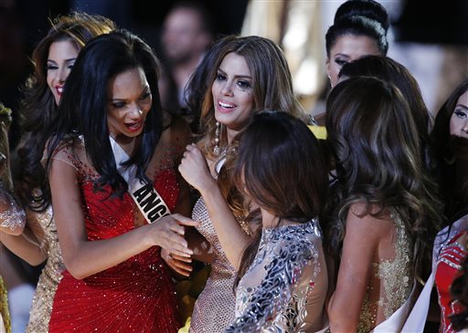 Other contestants comfort Miss Colombia Ariadna Gutierrez, center, after she was incorrectly crowned Miss Universe at the Miss Universe pageant Sunday, Dec. 20, 2015, in Las Vegas. According to the pageant, a misreading led the announcer to read Miss Colombia Ariadna Gutierrez as the winner before they took it away and gave it to Miss Philippines Pia Alonzo Wurtzbach. (AP Photo/John Locher)