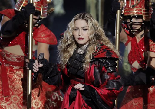 FILE - In this Feb. 20, 2016 file photo, U.S. singer Madonna performs during the Rebel Heart World Tour in Macau, China. Madonna has angered fans by starting a concert in the Australian city of Brisbane more than two hours late and finishing the show early Thursday morning, March 17 after the last train had left the venue. (AP Photo/Kin Cheung, File)
