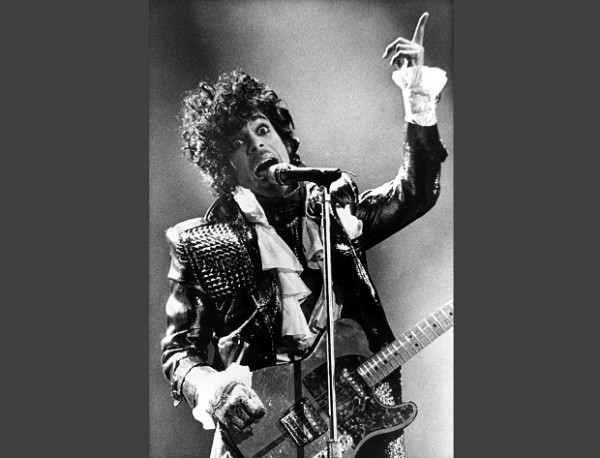 In this Jan. 22, 1985 file photo, Prince performs in concert at Riverfront Coliseum during his Purple Rain Tour in Cincinnati, Ohio. Prince's publicist has confirmed that Prince died at his home in Minnesota, Thursday, April 21, 2016. He was 57. AP FILE PHOTO