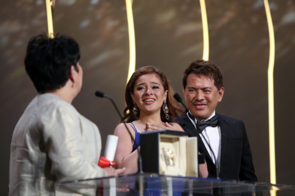 Actress Jaclyn Jose, left looks at actress Andi Eigenmann, centre and director Brillante Mendoza, after winning the Best Actress award for the film Ma' Rosa, at the awards ceremony at the 69th international film festival, Cannes, southern France, Sunday, May 22, 2016. (AP Photo/Thibault Camus)