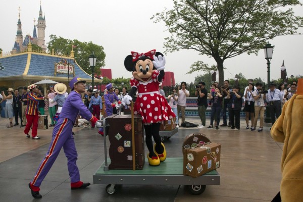A Disney character takes part in a parade on the eve of the opening of the Disney Resort in Shanghai, China, on June 15. The Walt Disney Company has recently sued three Chinese companies over copyright infringement. AP