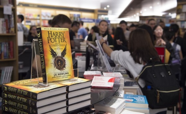 Stacks of new book "Harry Potter and the Cursed Child" are displayed at a book store during its launch in Singapore on July 31, 2016. Rowling's books have sold more than 450 million copies of harry Potter since 1997 and been adapted into eight films. / AFP PHOTO / ROSLAN RAHMAN