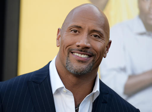 FILE - In this June 10, 2016 file photo, Dwayne Johnson attends the premiere of his film, "Central Intelligence"  in Los Angeles.  Johnson is the highest-paid actor with a fast and furious income of $64.5 million, according to Forbes magazine. Johnson, the former wrestler whose income swelled thanks to the films “Central Intelligence” and “Fast 8,” beat out Jackie Chan with $61 million and Matt Damon, who earned $55 million. AP/INVISION FILE PHOTO