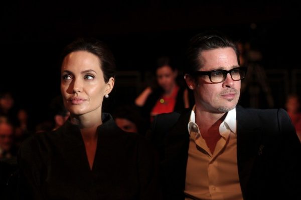 (FILES) This file photo taken on June 13, 2014 shows US actress and special UN envoy Angelina Jolie (L) and her husband US actor Brad Pitt attending the fourth day of the Global Summit to End Sexual Violence in Conflict in London. US actress Angelina Jolie has filed for divorce from her husband Brad Pitt after two years of marriage and 12 years together, announced on September 20, 2016 by the website TMZ celebrity. / AFP PHOTO / Carl COURT