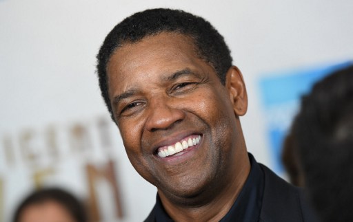 (FILES) This file photo taken on September 19, 2016 shows actor Denzel Washington attends the 'The Magnificent Seven' New York premiere at the Museum of Modern Art in New York. "The Magnificent Seven," a remake of the classic 1960 Western, starring Denzel Washington, outgunned the competition at the North American box office in its debut week, industry data showed on September 25, 2016. / AFP PHOTO / ANGELA WEISS