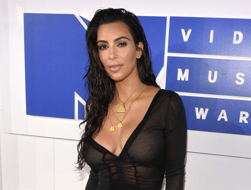 In this Aug. 28, 2016 file photo, Kim Kardashian West arrives at the MTV Video Music Awards in New York. Kardashian West is suing online media outlet, MediaTakeOut.com, saying she was wrongly portrayed as a liar and thief after she was attacked in Paris. Police say armed robbers forced their way into a private residence where Kardashian West was staying on Oct. 3, tied her up and stole $10 million worth of jewelry. (Photo by Chris Pizzello/Invision/AP, File)